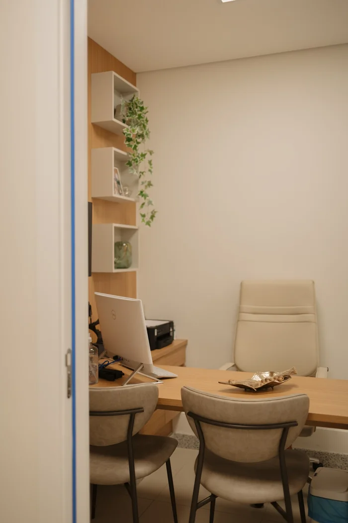 Mesa de atendimento vista em ângulo, com cadeiras para o paciente